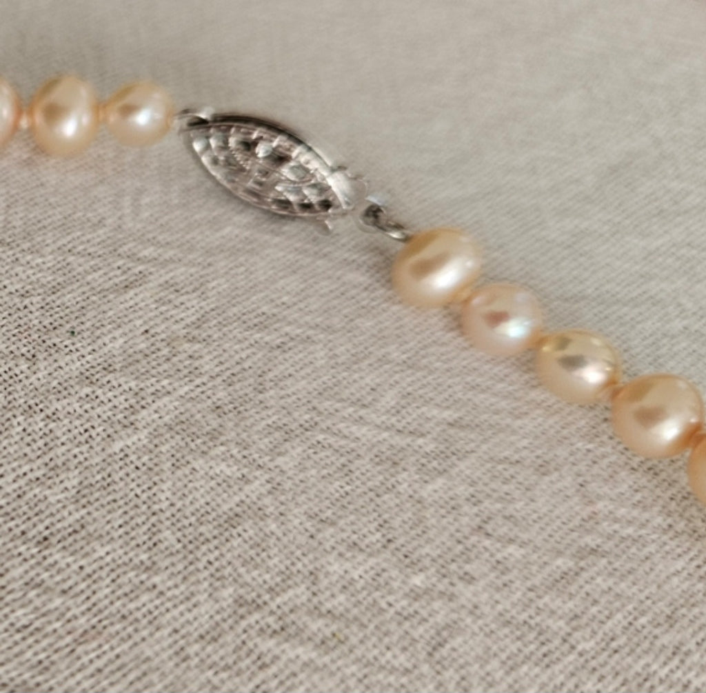 Graduated Cultured Peach Necklace. Peach color with Sterling Silver Clasp