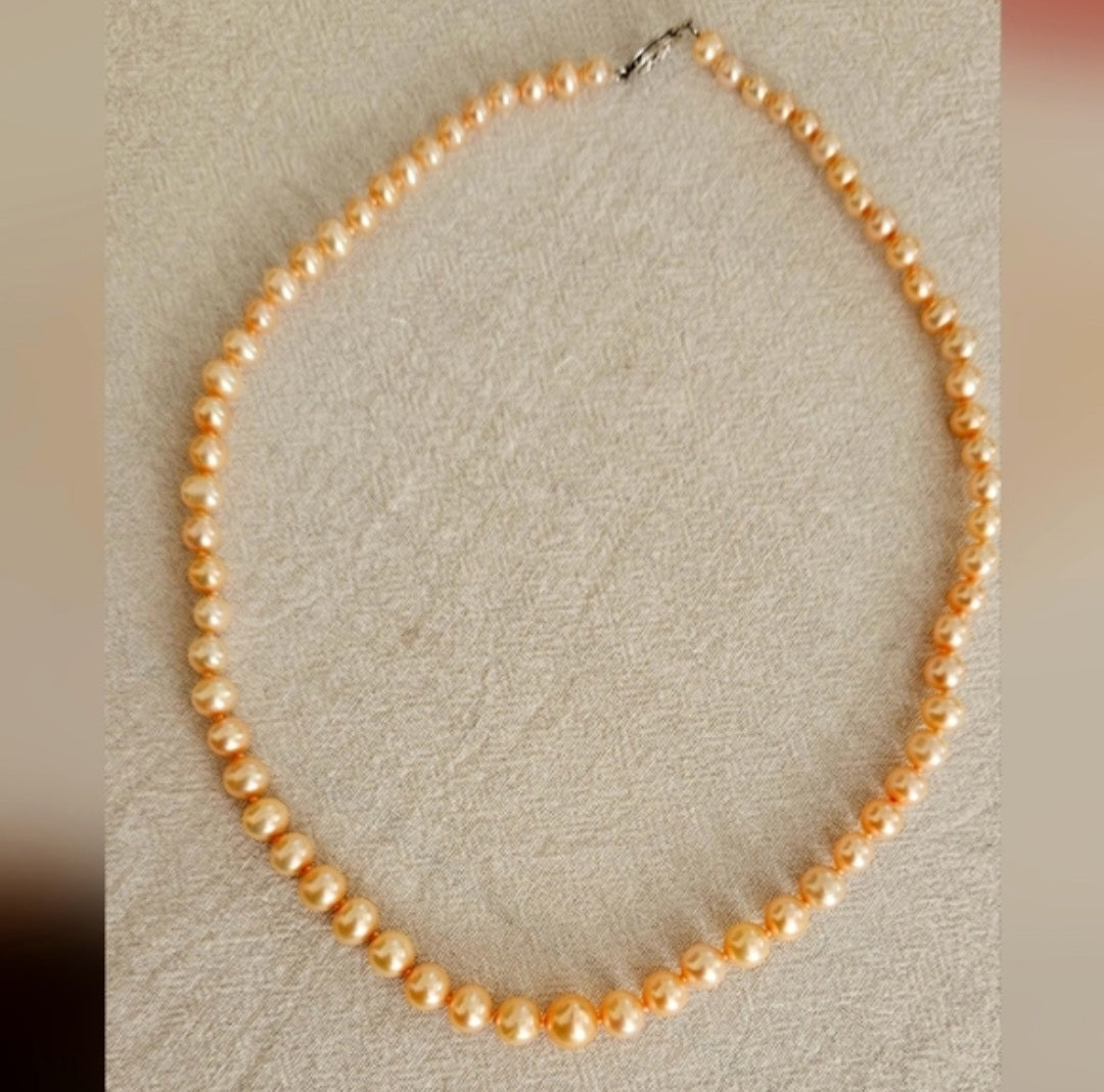 Graduated Cultured Peach Necklace. Peach color with Sterling Silver Clasp